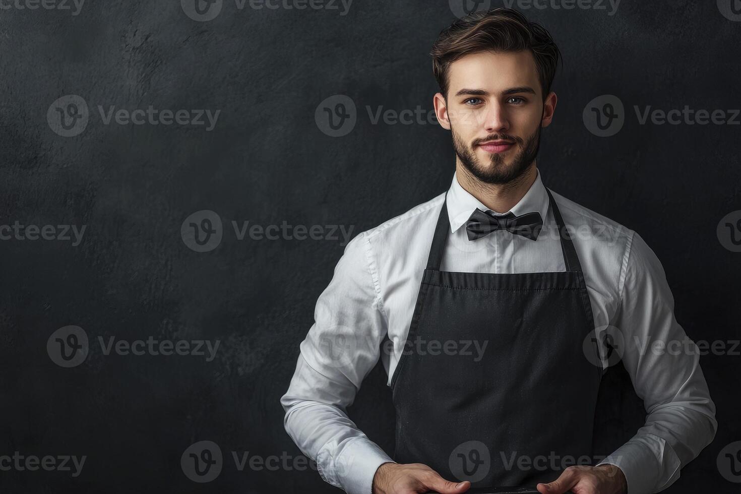 Portrait of Smiling Man Wearing Apron and Bow Tie in Studio photo