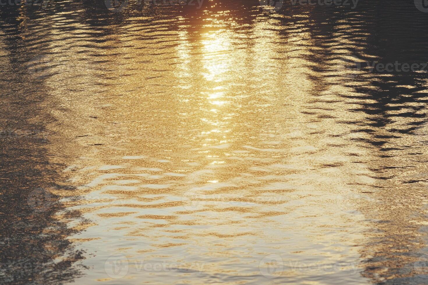 Water Surface Reflecting Sunlight Creating Ripples and Shimmering Golden Light photo
