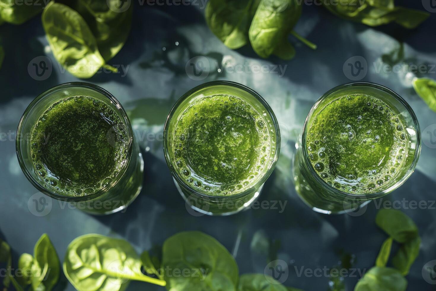 Three Glasses of Green Smoothie with Fresh Spinach on Dark Background photo