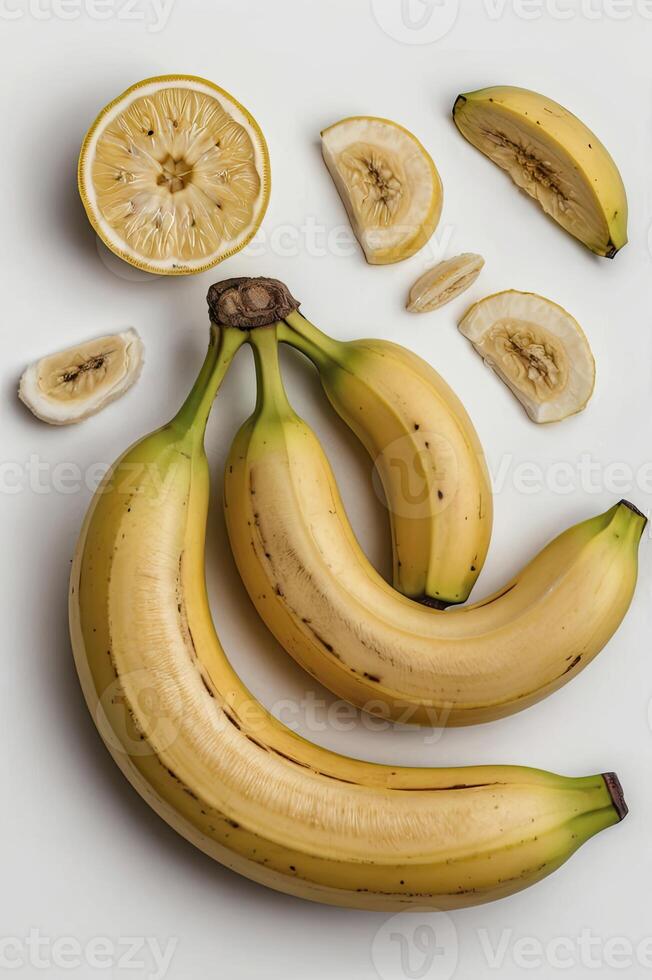 Fresh Bananas and Lemon Slices on a White Surface Still Life photo