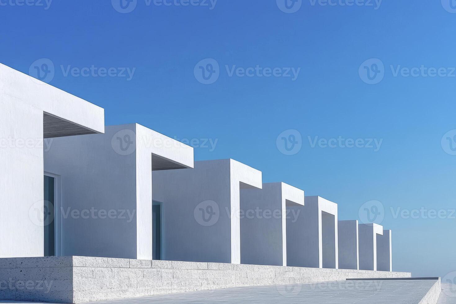 Minimalist White Architecture Under Clear Blue Sky Serene and Modern photo
