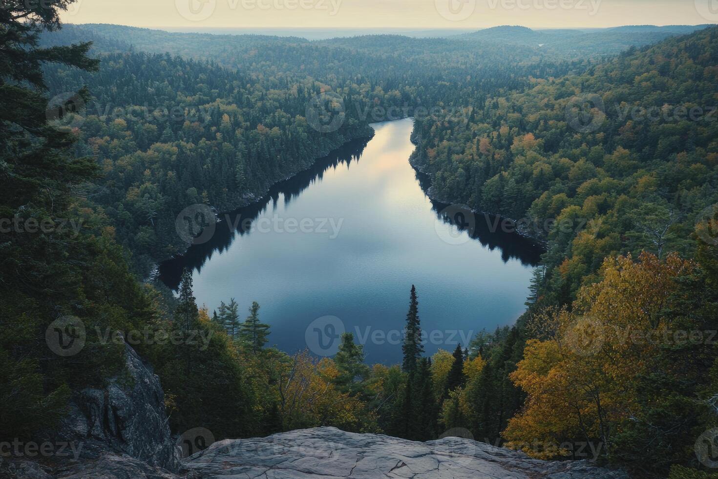 Overlooking Serene Lake Surrounded by Dense Forest in Autumn Landscape photo