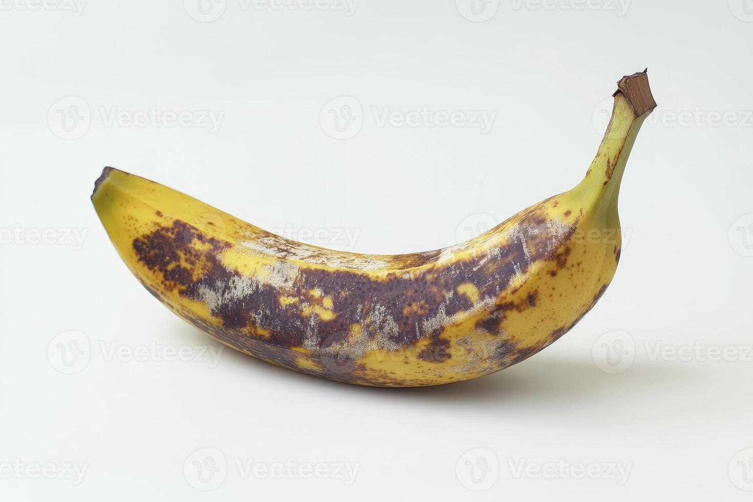 Ripe Banana with Brown Spots on White Background Ready for Baking photo