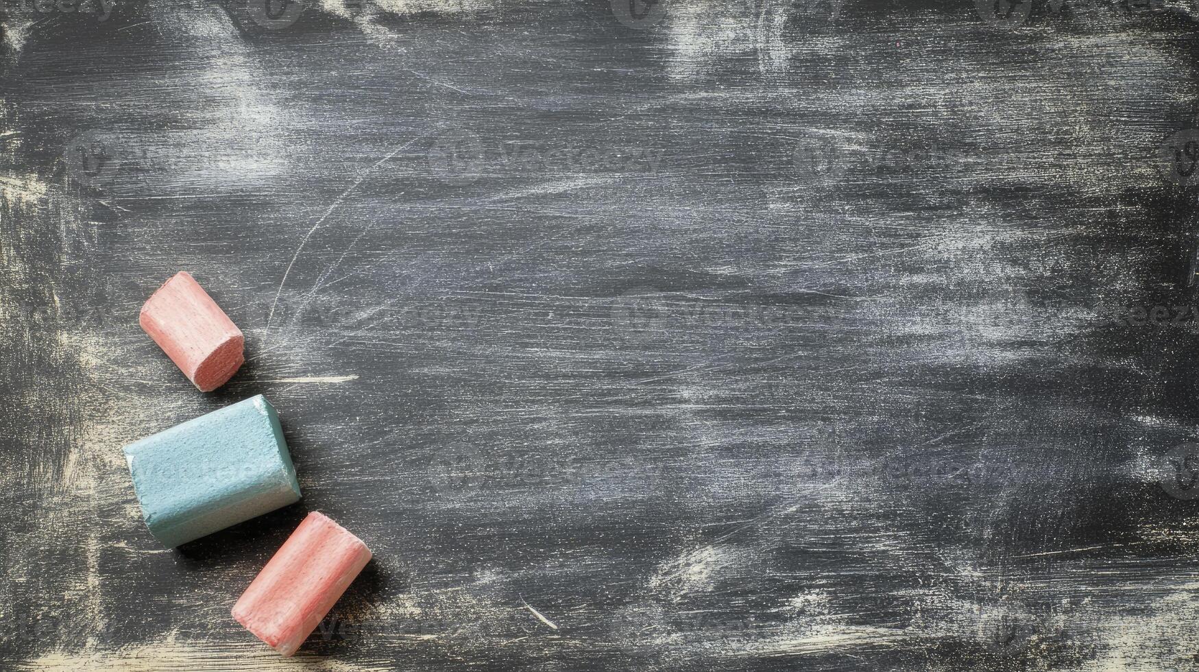 Chalk on Blackboard Background with Colorful Pieces for Education Mockups photo