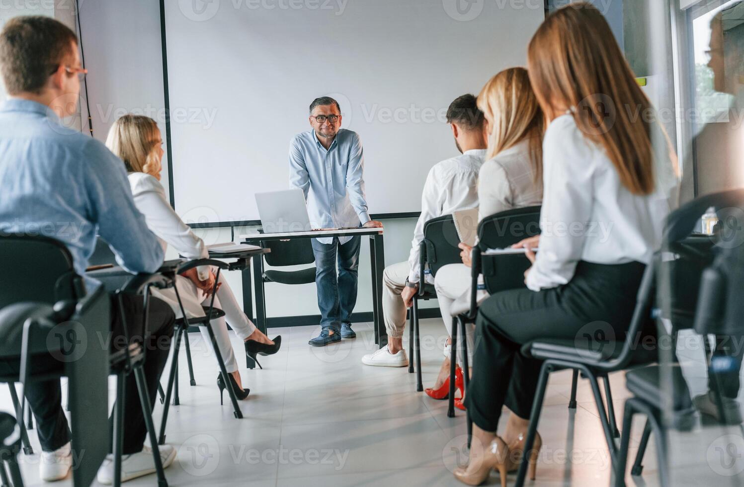 Explaining new stuff for students... Group of professional business people is in the office photo
