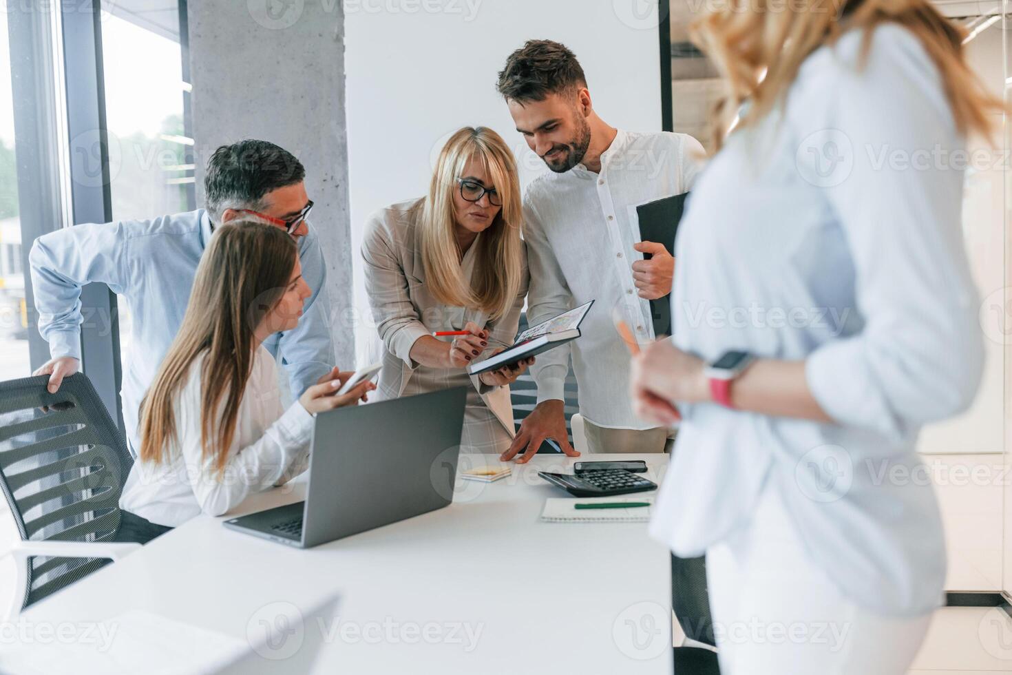 Conception of unity and teamwork. Group of professional business people is in the office photo