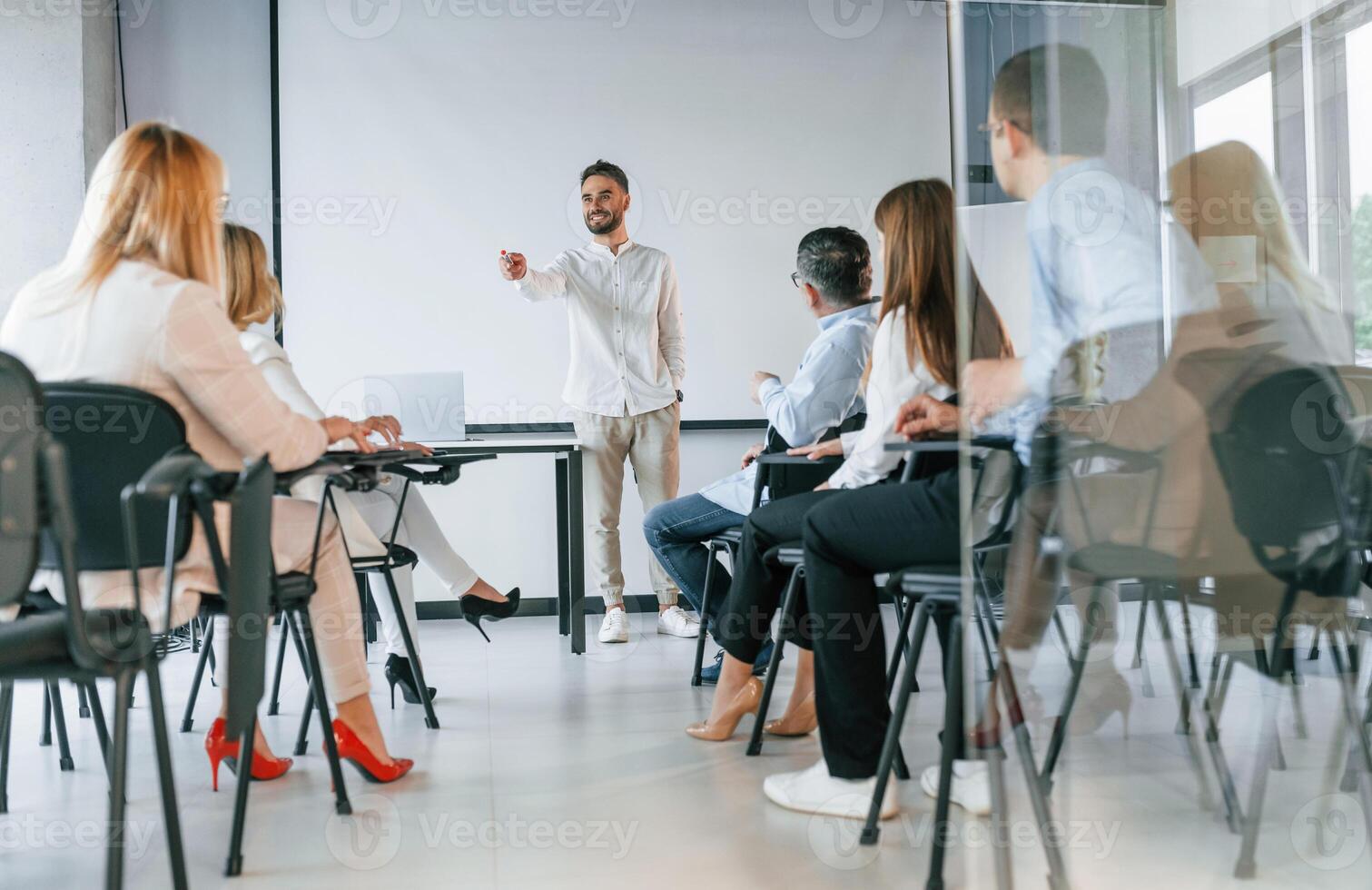 Man ,is teaching and making master class. ,Group of professional business people is in the office photo