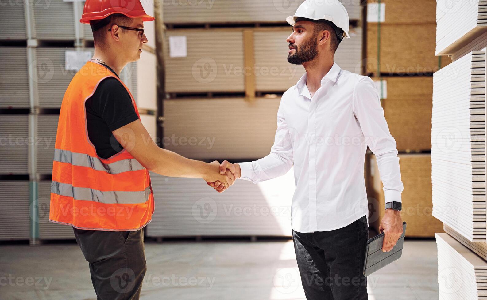 Standing together.. Two storage workers is in the warehouse photo