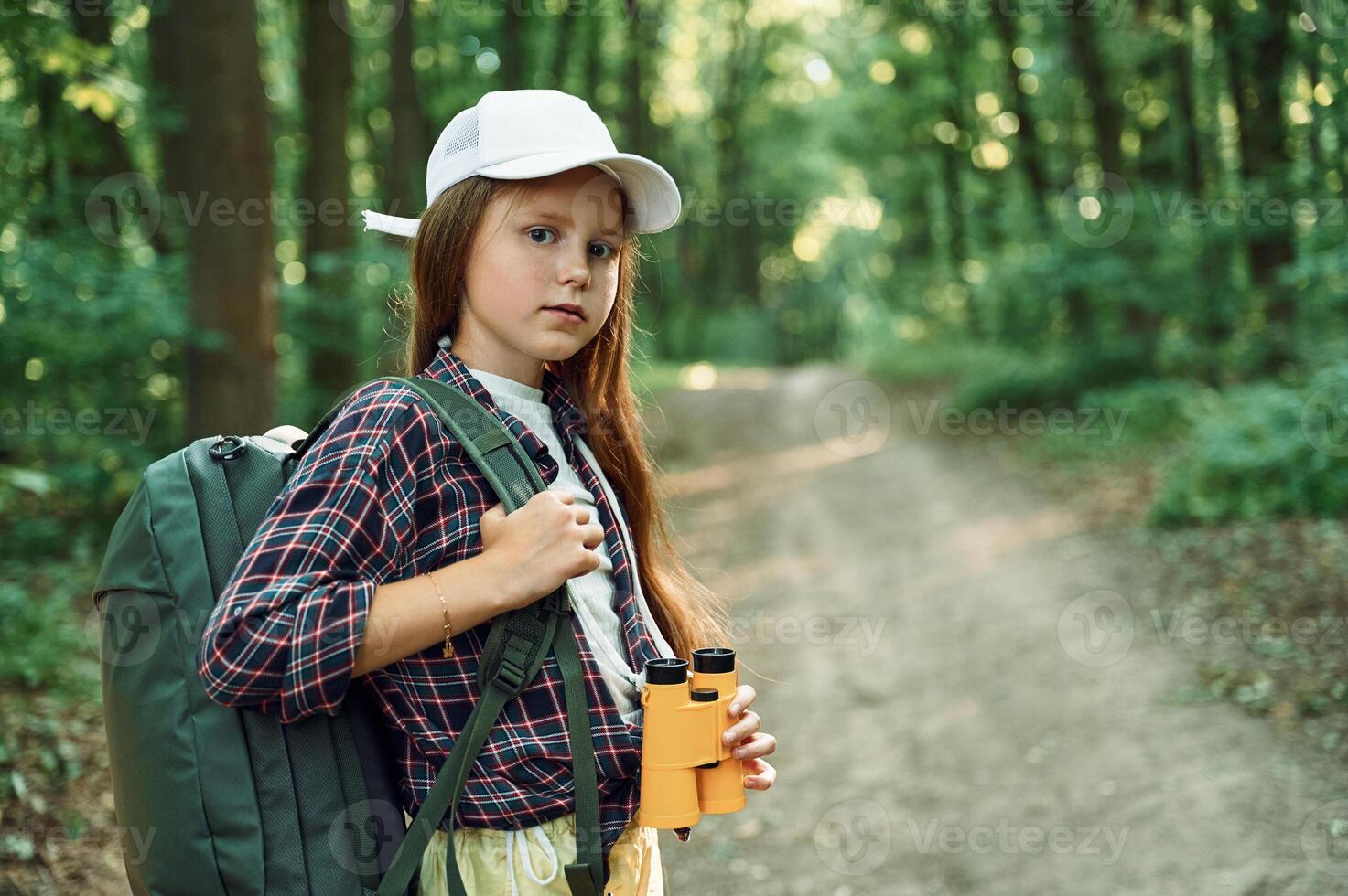 Portrait of girl ,that is in the forest at summer day time discovering new places photo