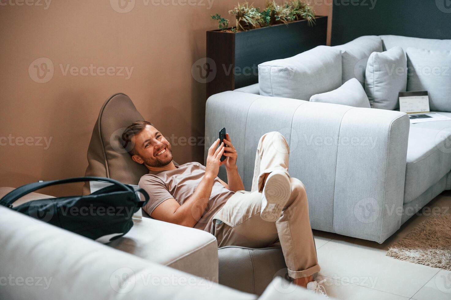 Sitting and enjoying. Customer, visiting the sofa and bed store. Looking for update photo