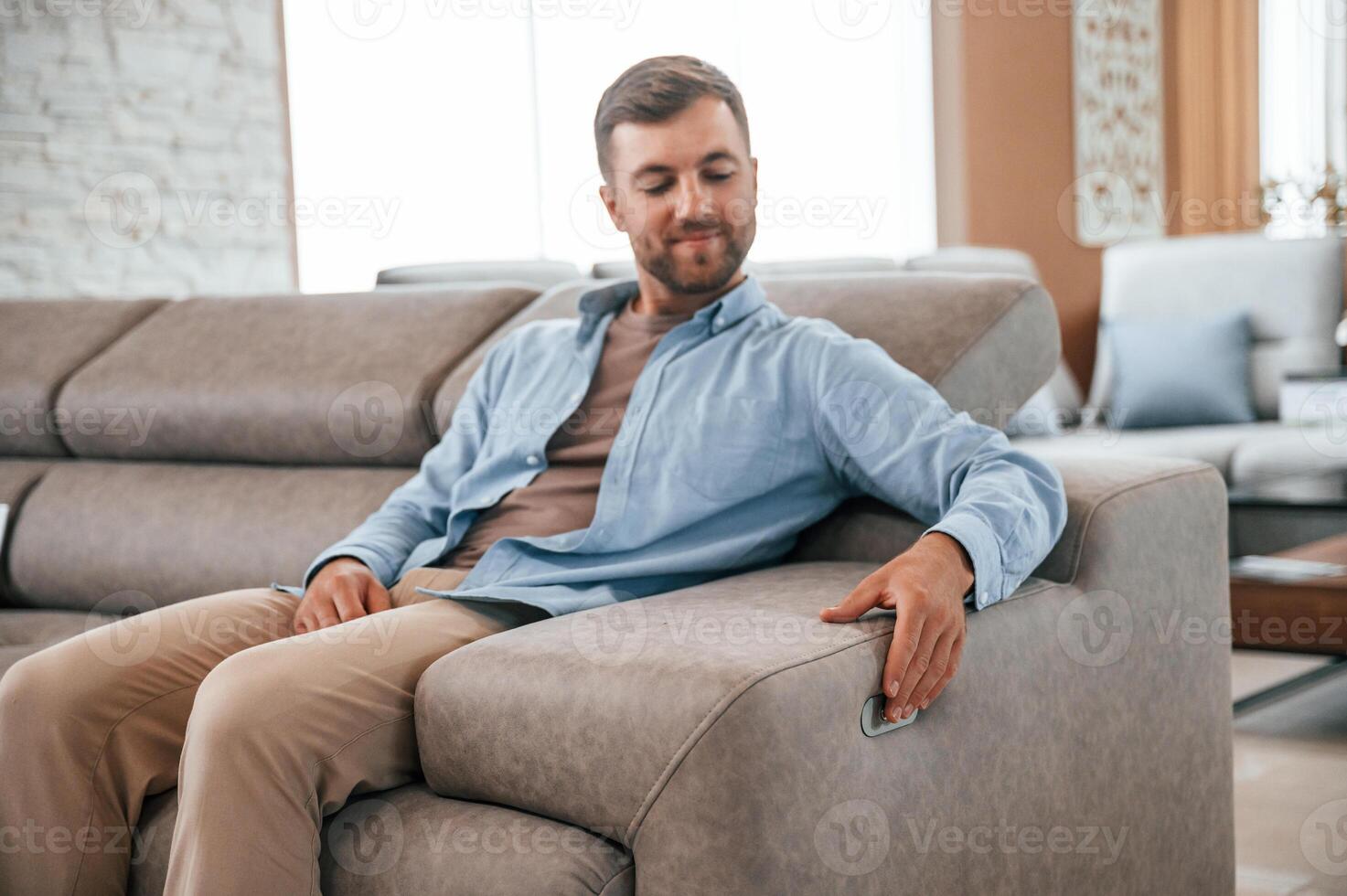 Sitting and enjoying. Customer visiting the sofa and bed store. Looking for update photo