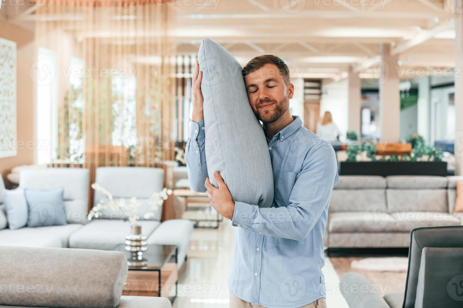 Embracing the pillow.. Customer visiting the sofa and bed store. Looking for update photo