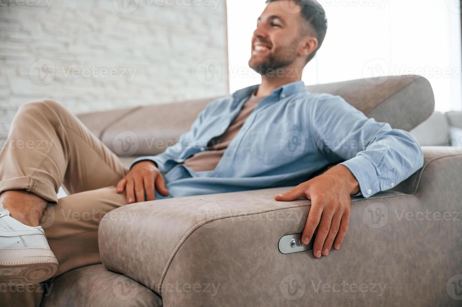 Sitting and ,enjoying. Customer visiting the sofa and bed store. Looking for update photo