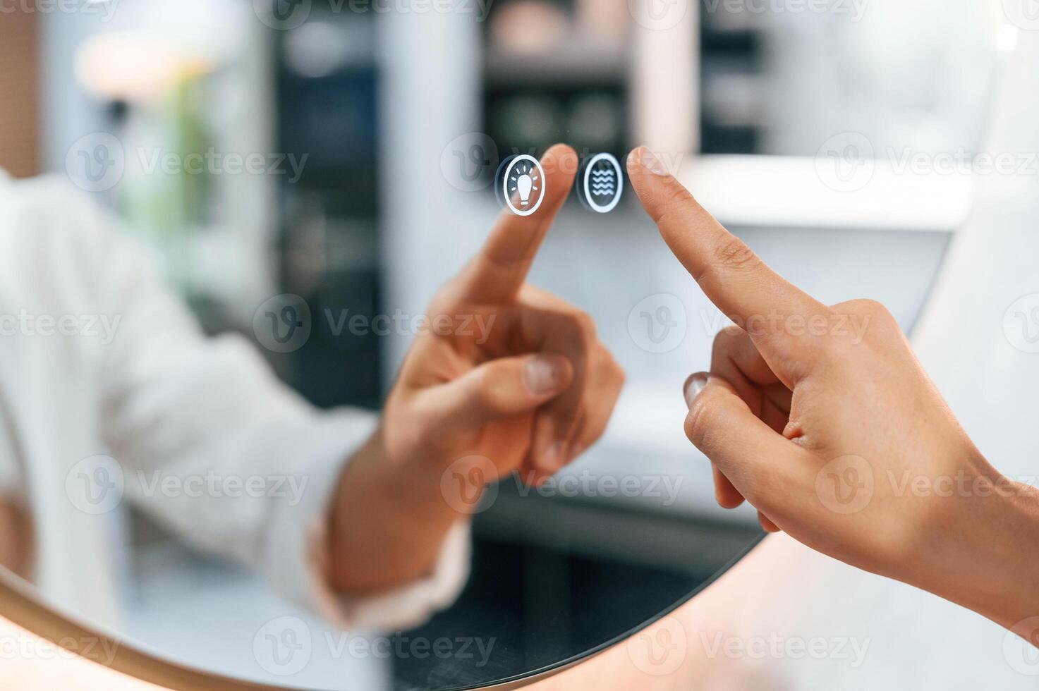 Using the .mirror with touchscreen feature. Pretty young woman is in the store of goods for the home photo