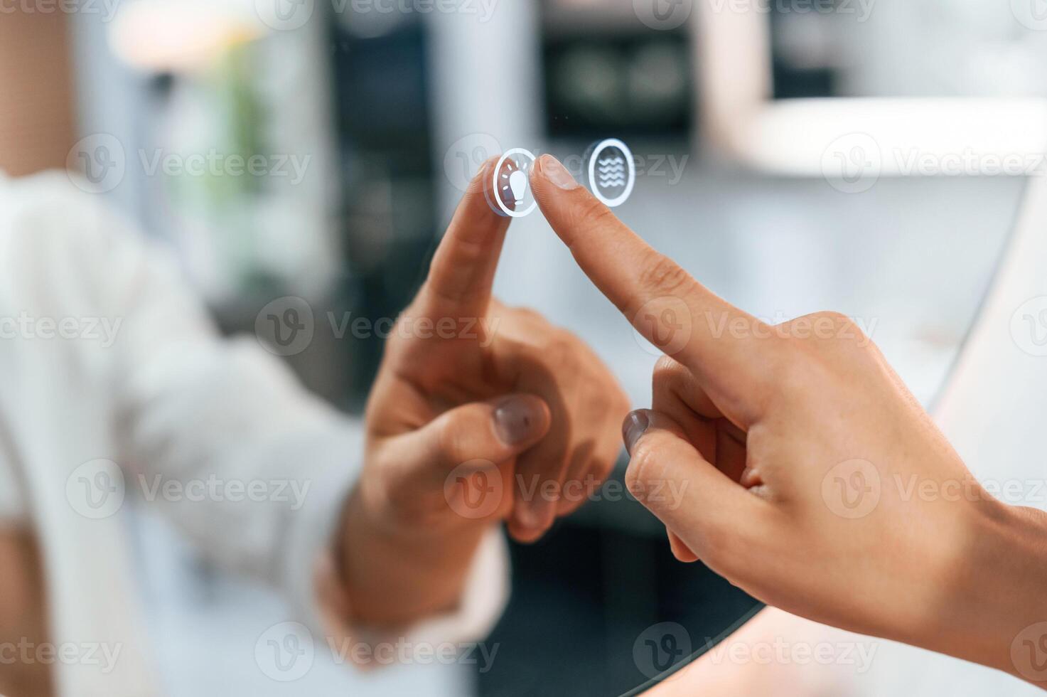 Using the mirror ,with touchscreen feature. Pretty young woman is in the store of goods for the home photo