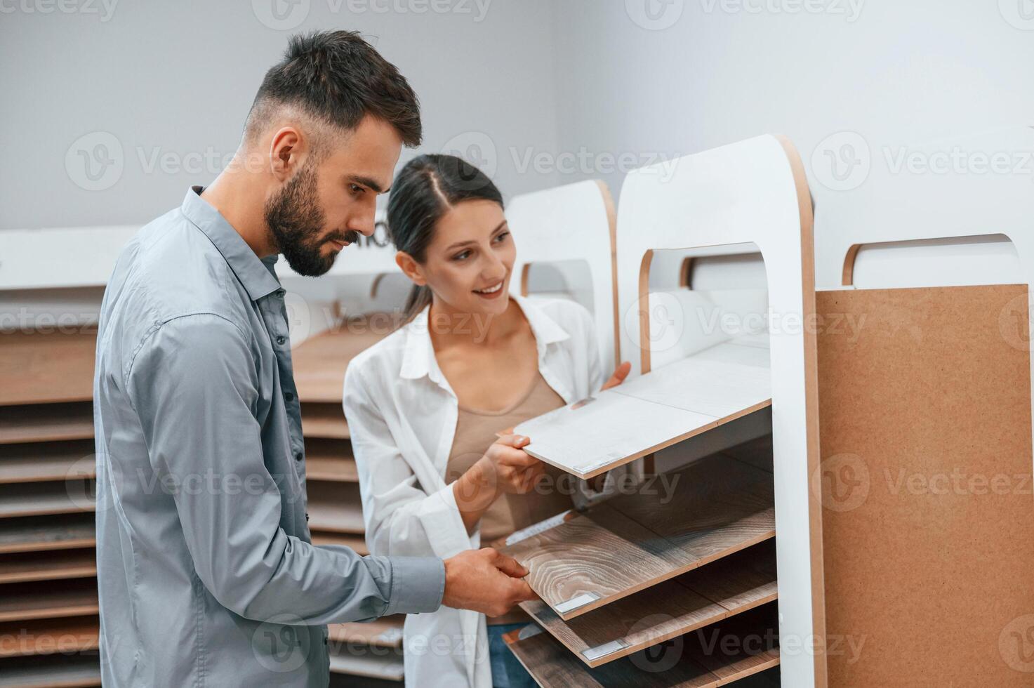 Quality, wood. Woman and man is in the store of goods for the home photo