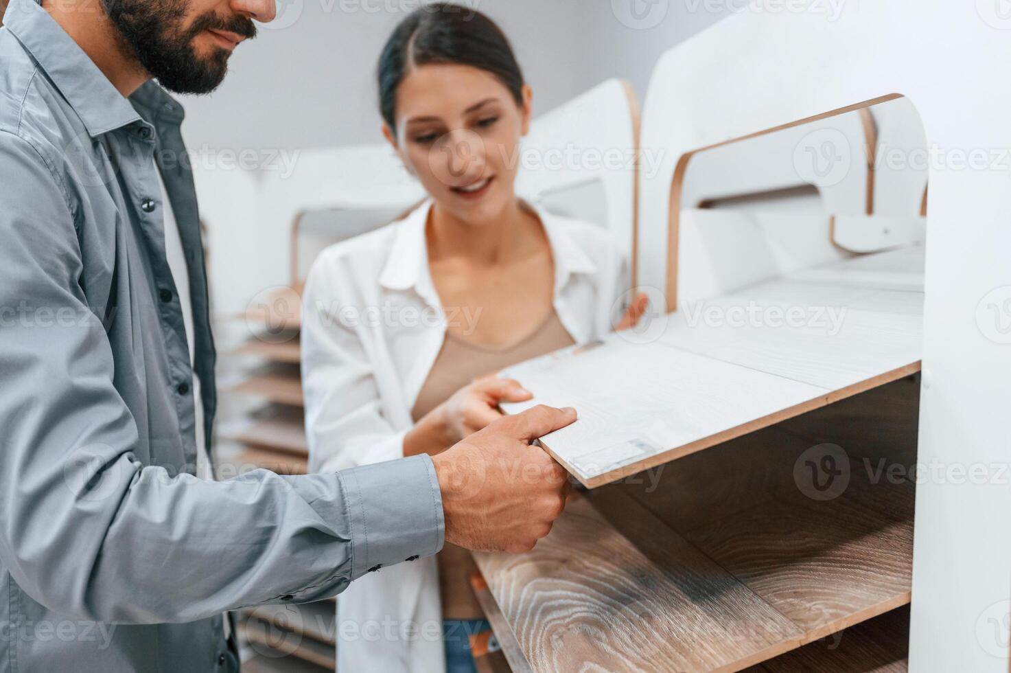 Quality, wood. Woman, and man is in the store of goods for the home photo