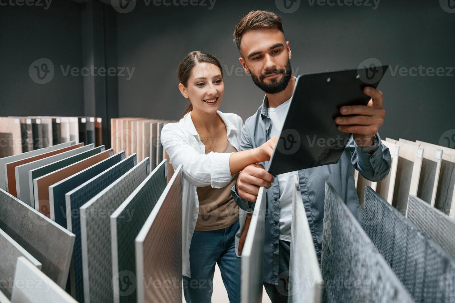 Manager, helping visitor. Woman and man is in the store of goods for the home photo