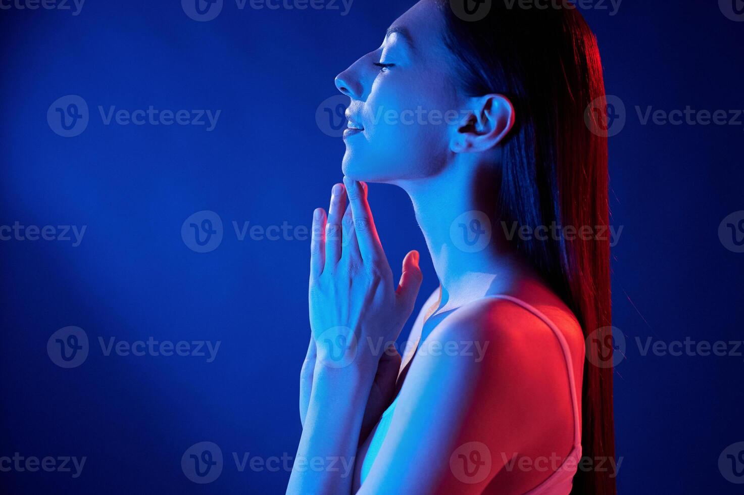 Feeling ,relaxed. Young woman in underwear is in the studio with neon lights photo
