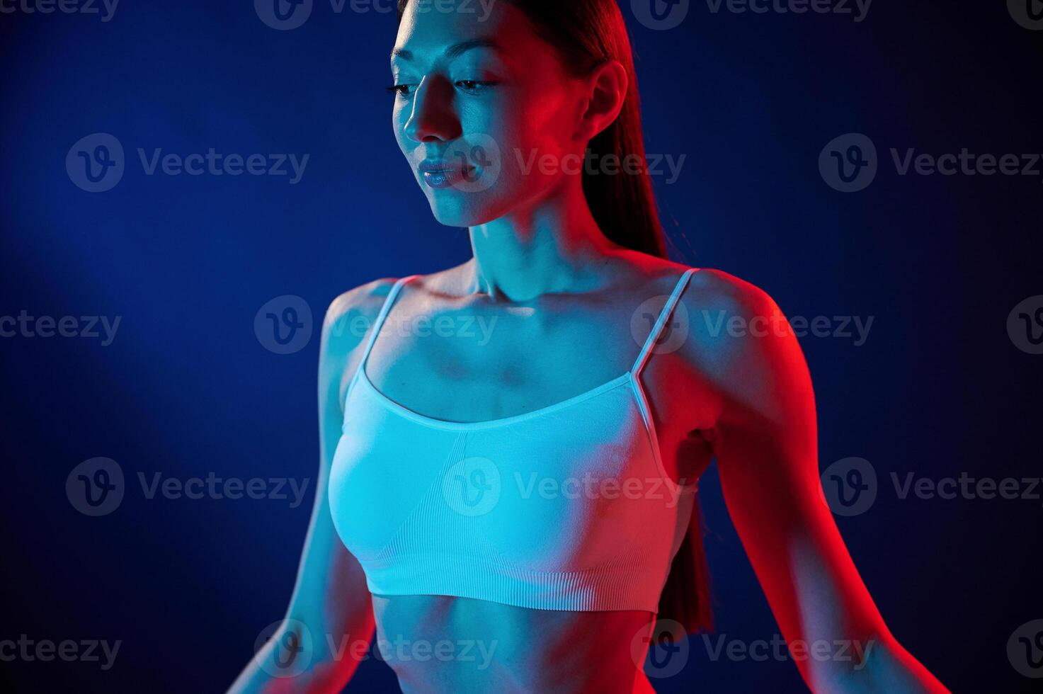 White top. Young, woman in underwear is in the studio with neon lights photo