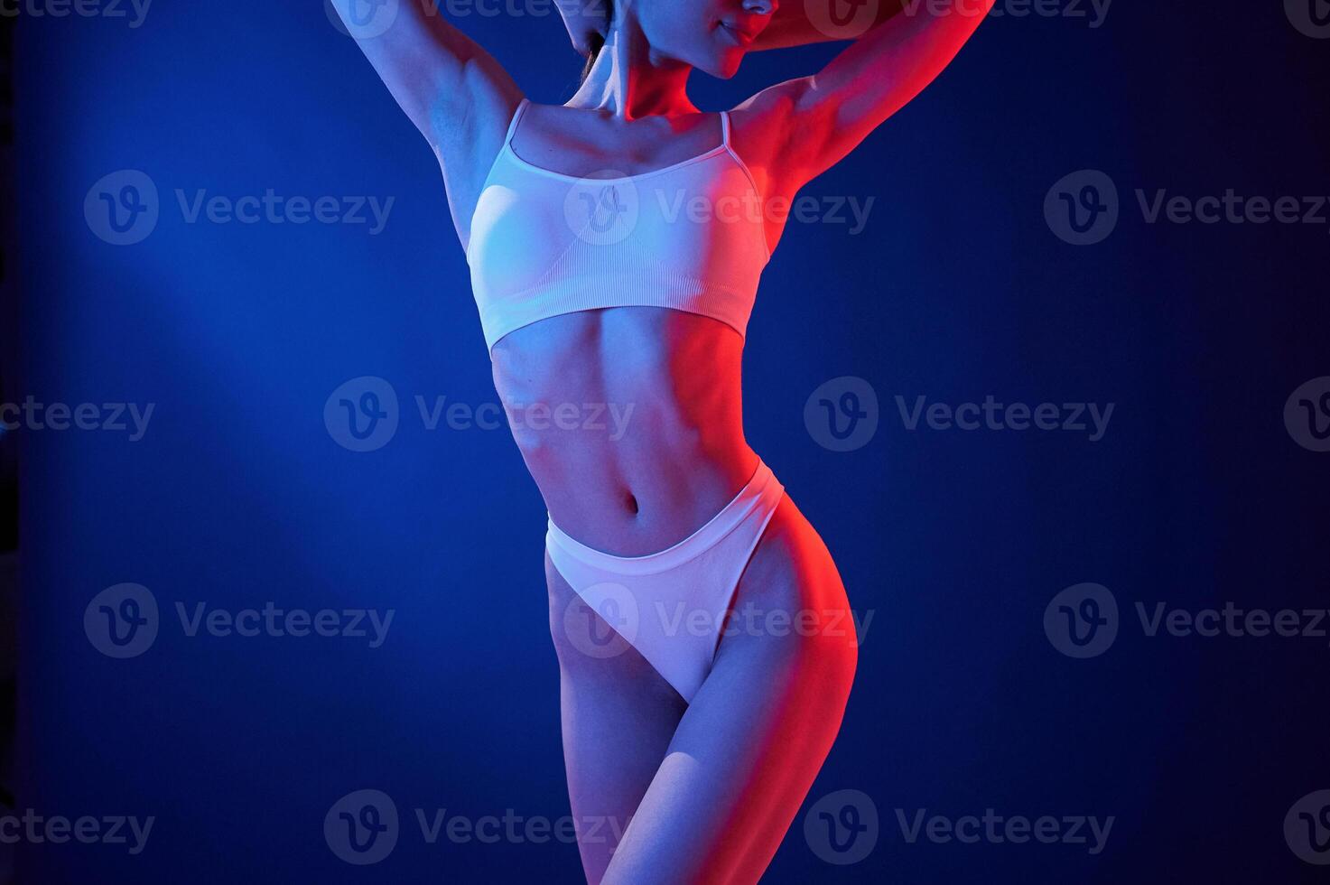 Close, up view. Young woman in underwear is in the studio with neon lights photo
