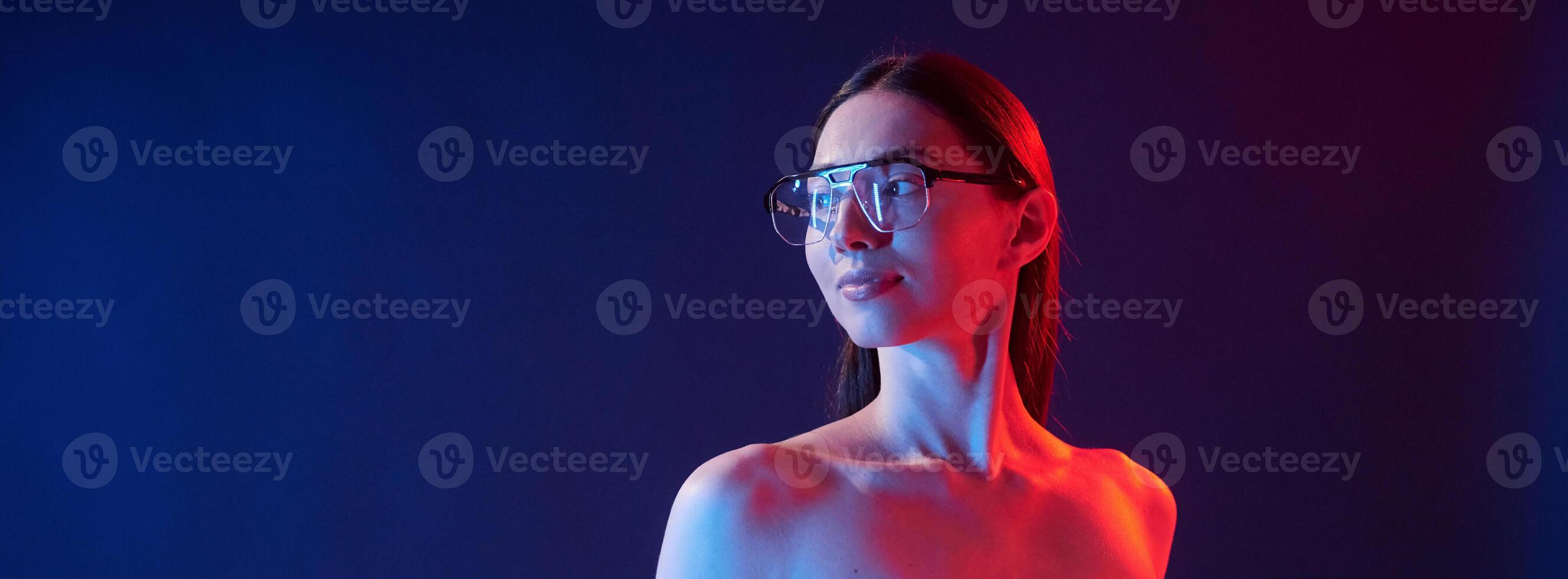 Futuristic neon lighting. Portrait of young woman that is indoors photo