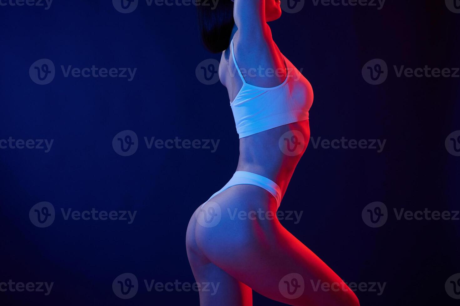 Fitness type body., Young woman in underwear is in the studio with neon lights photo