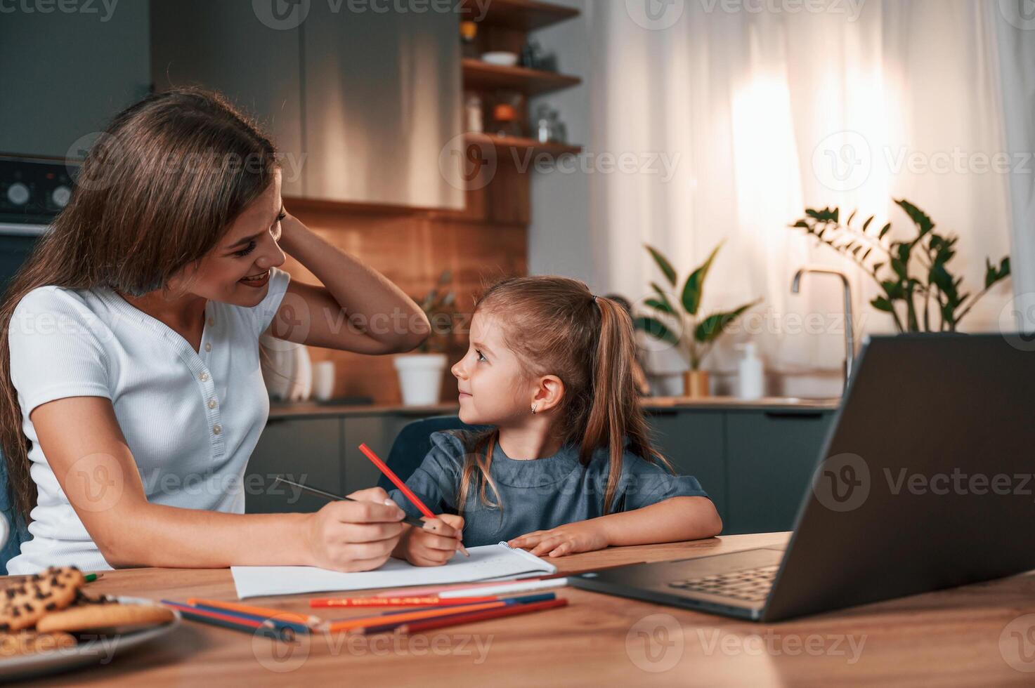 Young mother with her ,daughter is together at apartment photo