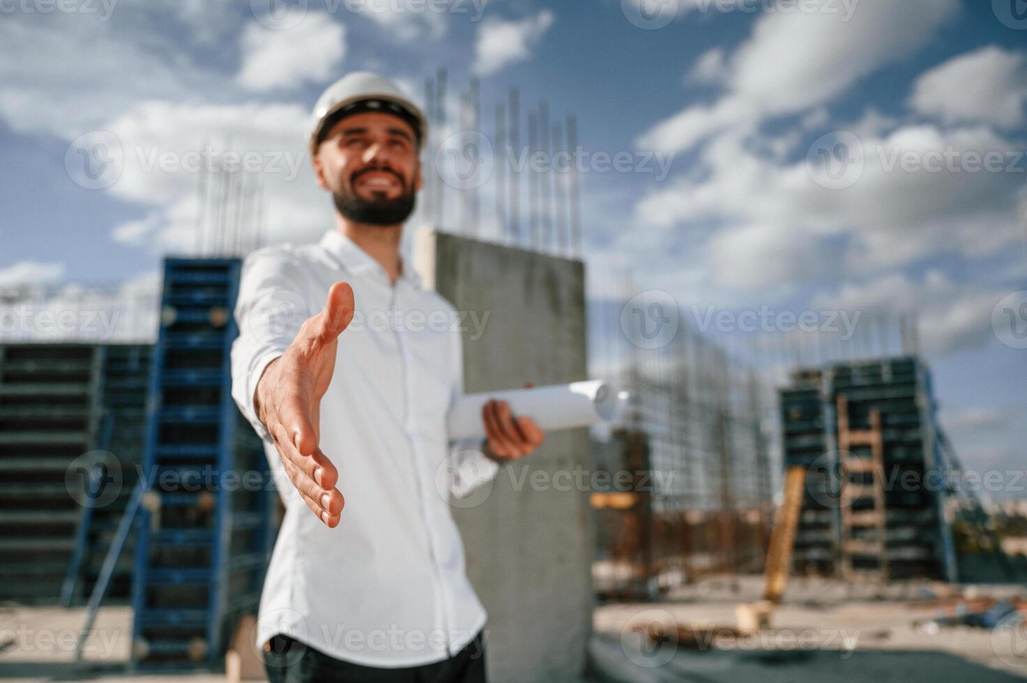 Making a deal. .Extending ,the hand. Man in uniform is working on the construction site photo