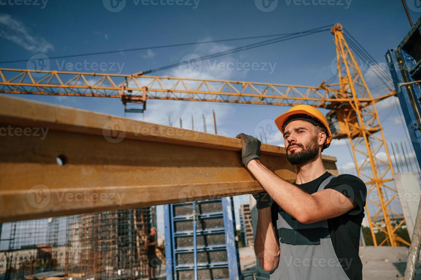 Man in uniform is working on the construction site photo