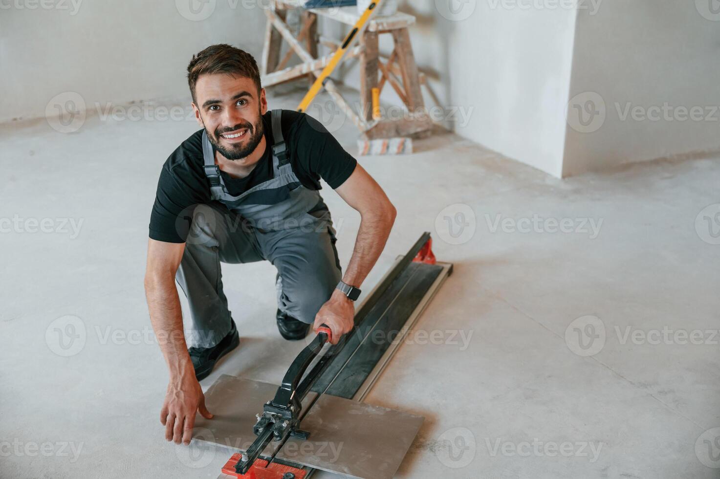 Tile cutting ,process. The man is making repairs in the apartment photo