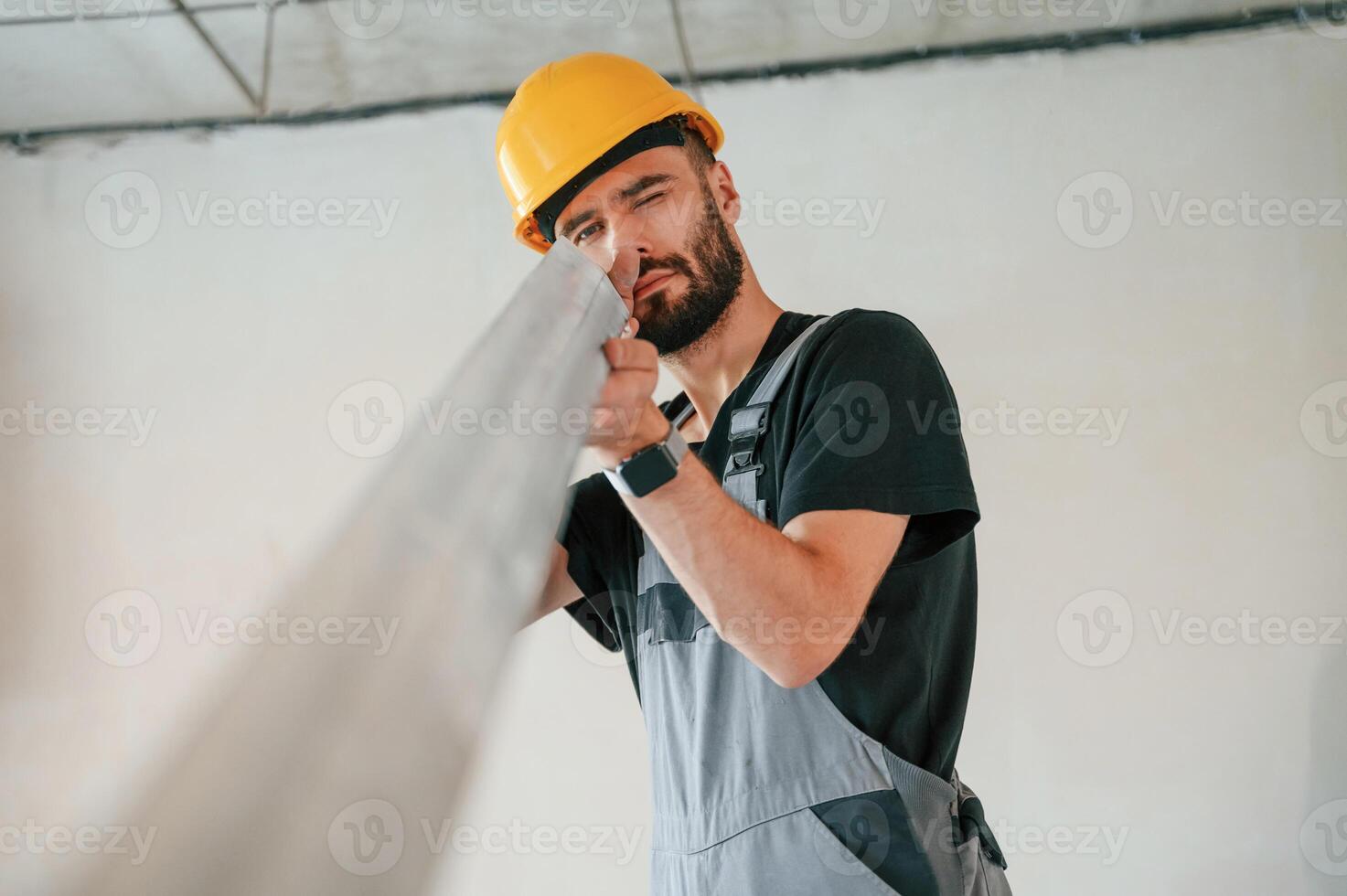 Holding ,construction material stuff by hands. The man is making repairs in the apartment photo