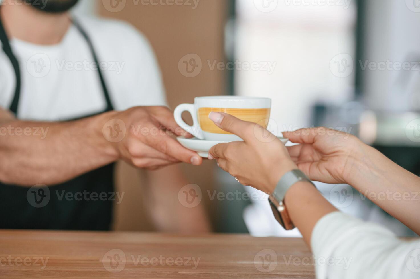 Close up view. Customer takes her order ,from barista in the cafe photo