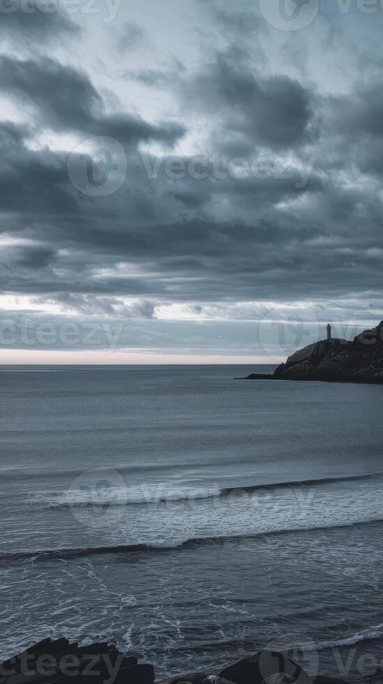 A lone lighthouse stands on the horizon in the distance photo