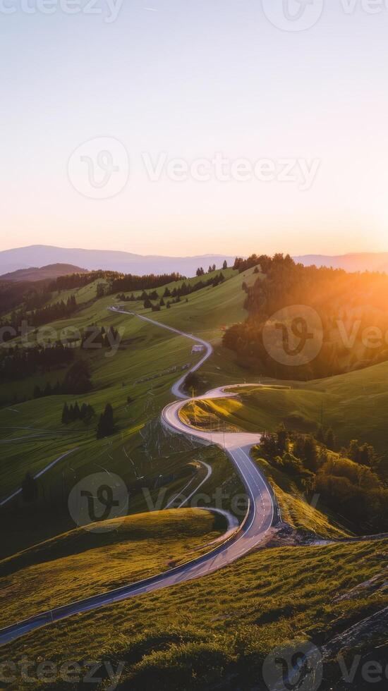 A winding road in the countryside at sunset photo