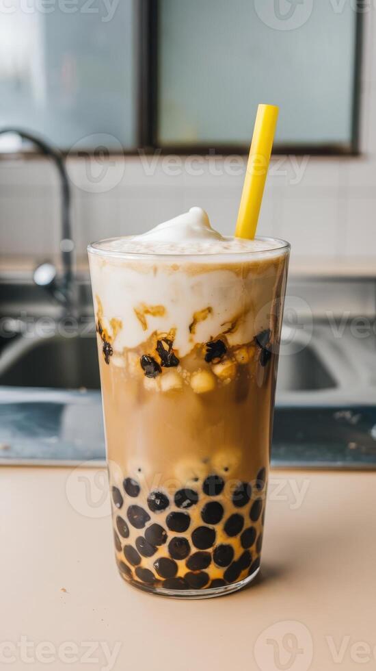 A glass of bubble tea with a yellow straw photo