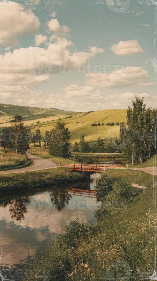 A bridge over a river in a field photo