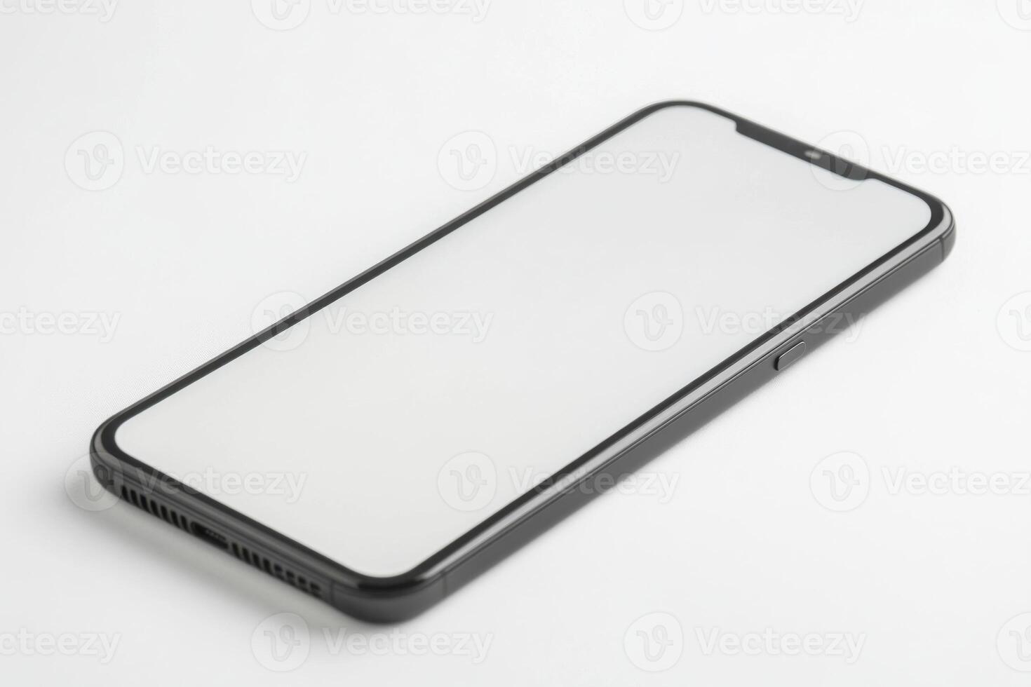 An iphone with a blank screen on a white surface photo