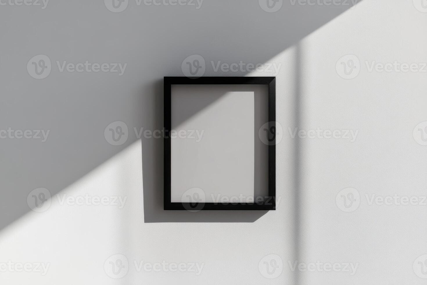 A black square frame on a wall with a shadow photo