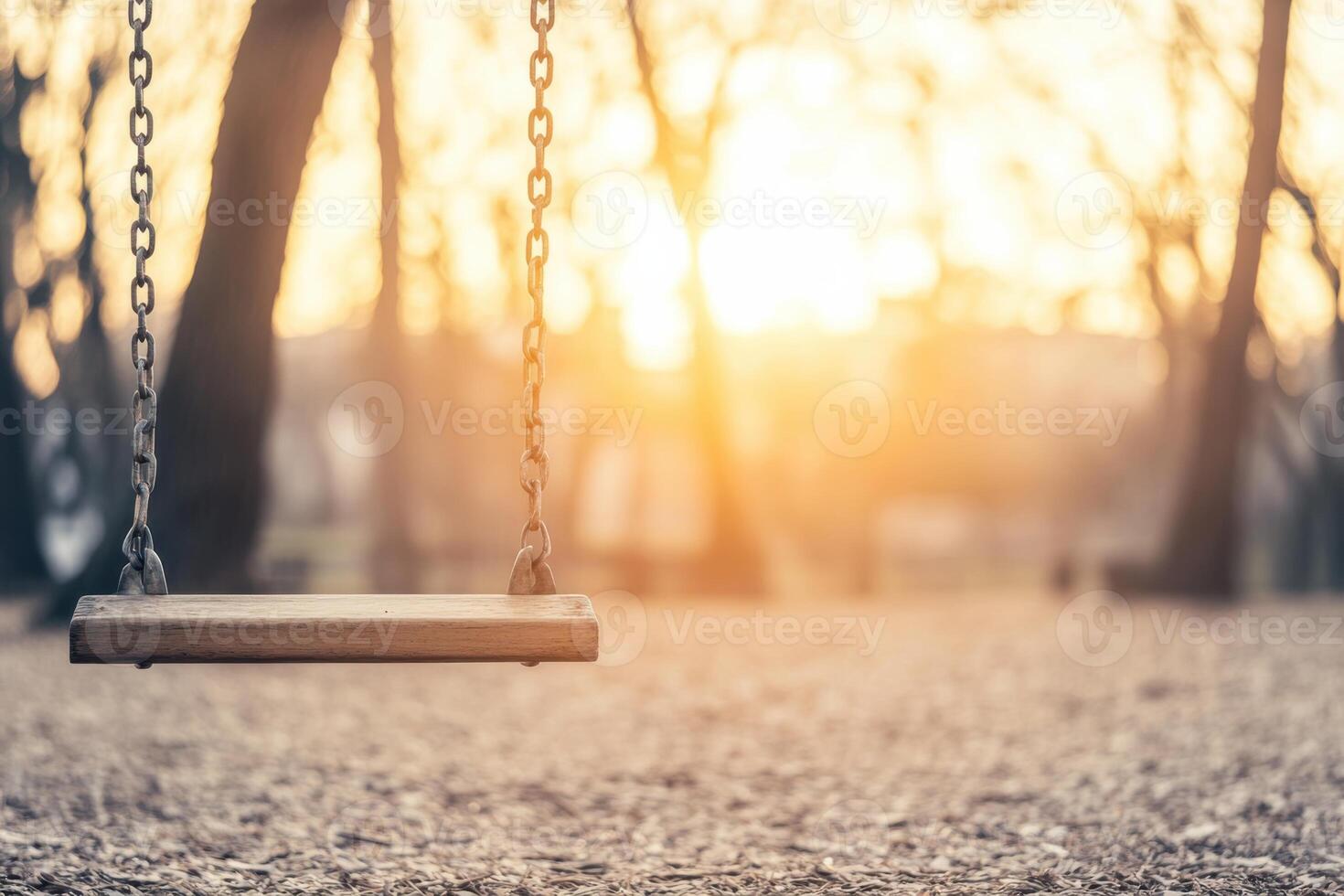 Lonely swing sways gently at sunset, embodying deep longing in an empty playground photo