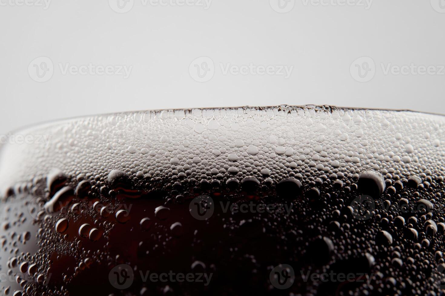Professional stock photo of a frothy beer glass with bubbles captured on a white background