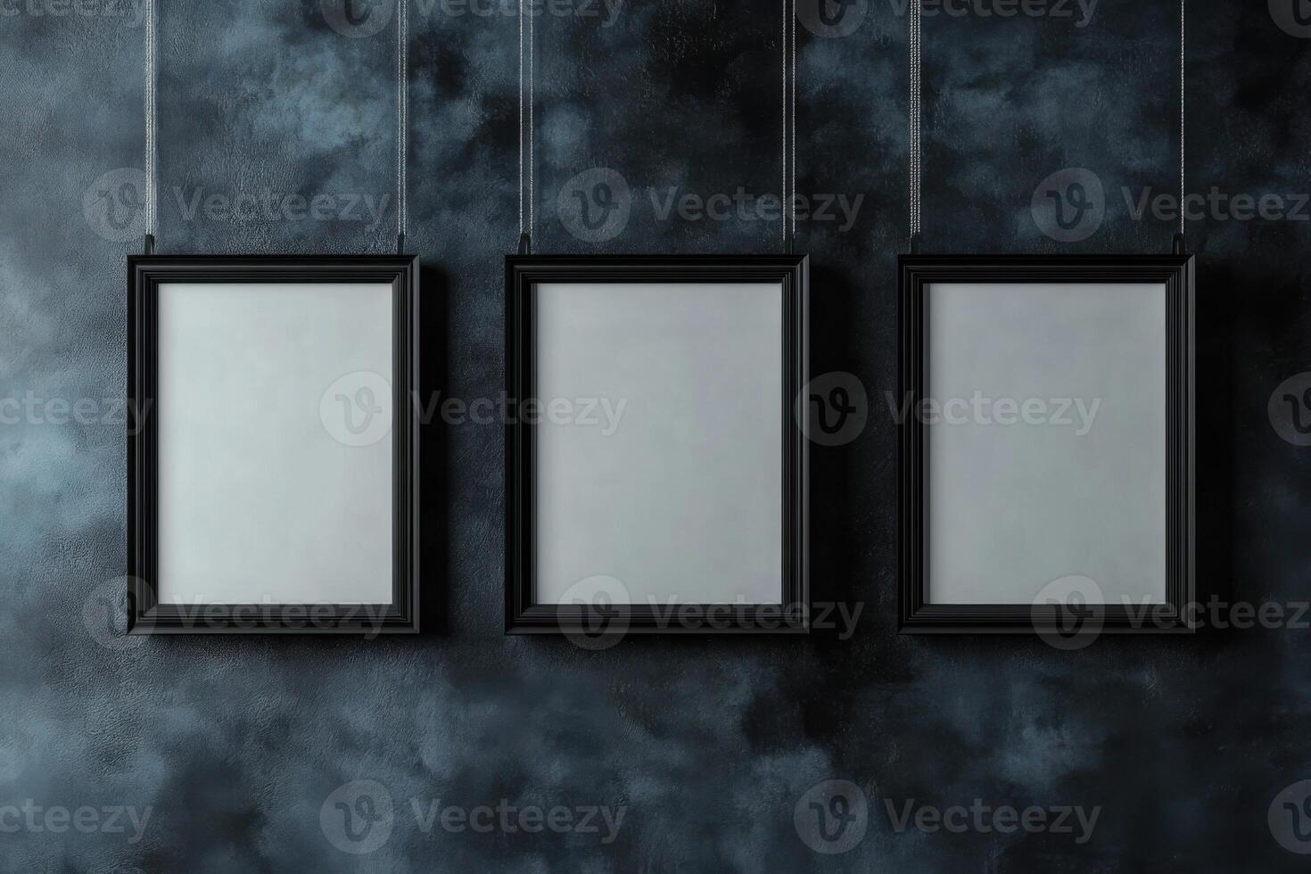Modern poster frames suspended against a dark textured background in a studio setting photo