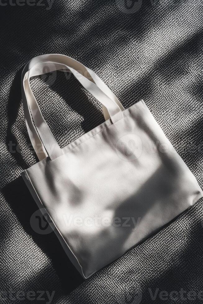 Elegant design of a plain tote bag resting flat on textured neutral surface photo