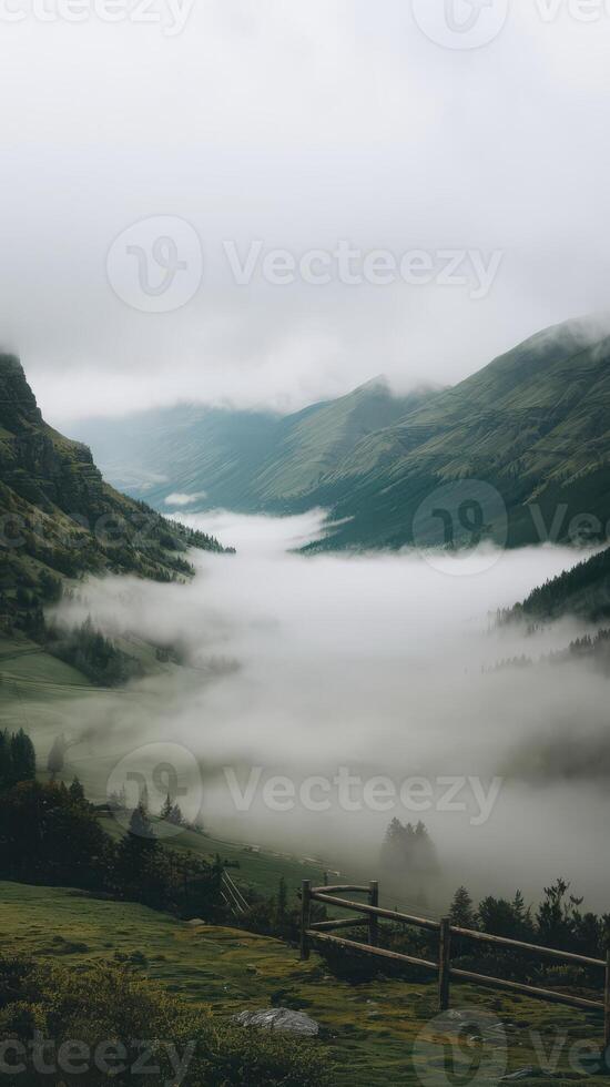 A view of a valley with fog and mountains photo