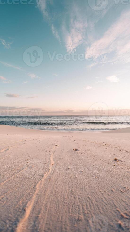 A beach with sand and water at sunset photo