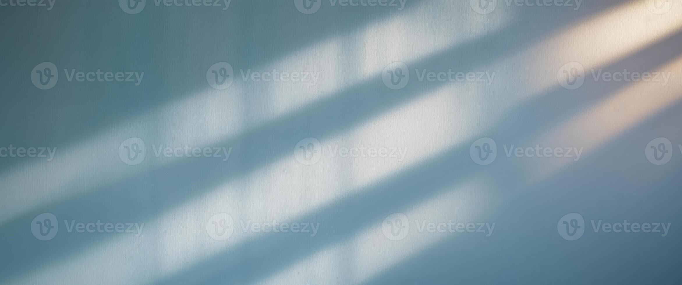 A white wall with some light coming through the window photo