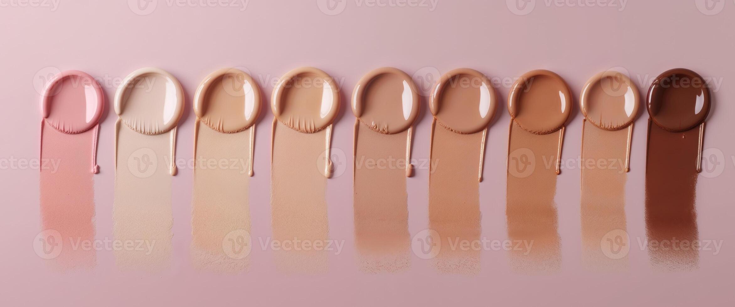 Cosmetic foundation swatches on a pink background showcasing a range of skin tones with Copy Space for text placement. photo