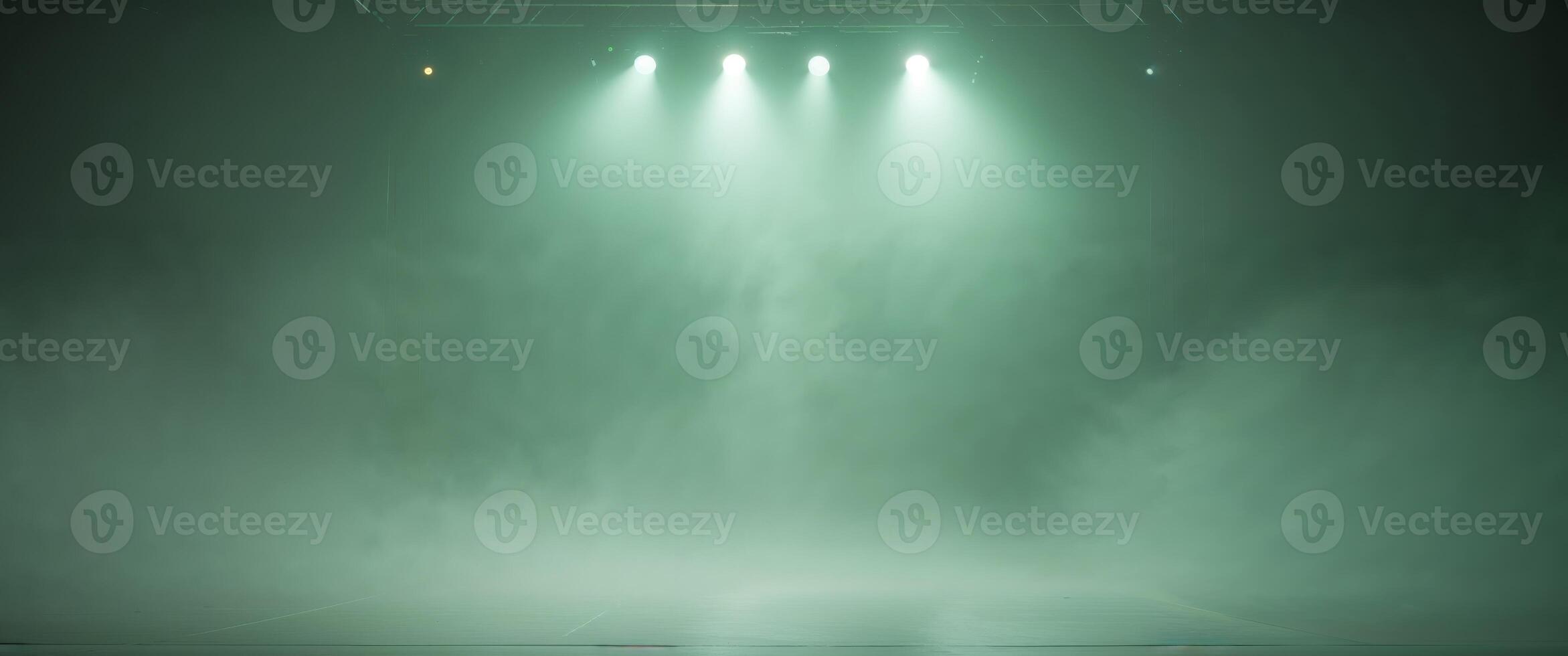 A green light shines on a stage with fog photo