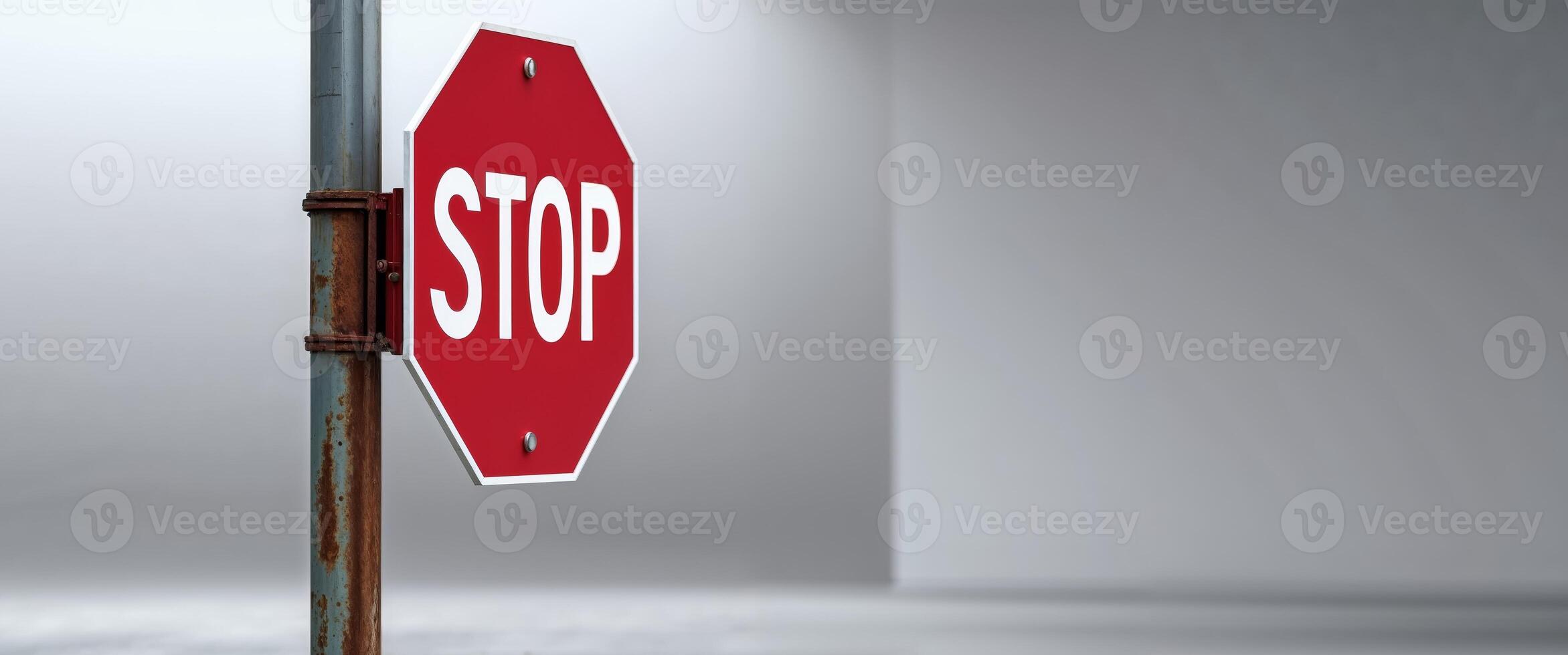 A stop sign is shown on a metal pole photo