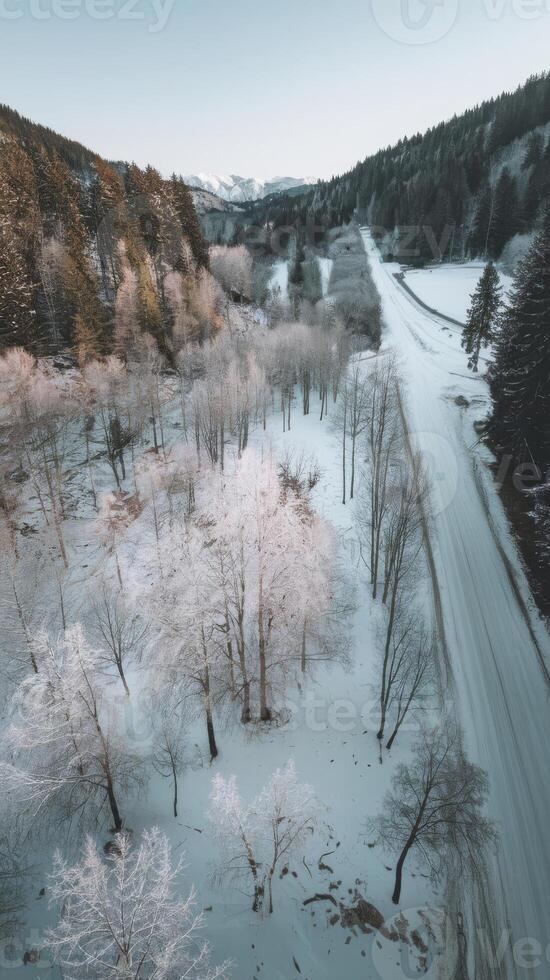 Aerial view of a snowy road in the mountains photo